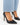 Black high-heeled shoes with a pointed toe, paired with light blue denim, showcasing a sleek and elegant design.
