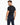A man with short hair and a beard is wearing a fitted black t-shirt and navy pants, showcasing a casual style.