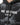 A close-up of a black sweatshirt featuring a lightning design and bold white text on the front.