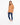 A model wearing a relaxed brown tee paired with distressed blue jeans and white sneakers, standing against a plain ba...