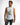 A man wearing a sleeveless white top with graphic prints and dark, faded jeans, posing against a light background.