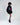 Model in black Lips Graphic oversized hoodie dress with ruched sleeves, streetwear aesthetic for Gen Z fashion.