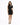 A woman poses in a fitted black dress with a high neckline and a cutout on one shoulder, paired with black heels.