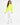 A woman walks confidently in a bright neon green turtleneck top paired with white joggers and sneakers.
