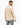 A man with short hair wears a textured beige top, showcasing a subtle geometric pattern from a rear view.