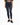 A person wearing dark blue skinny jeans paired with a cropped graphic t-shirt and black sneakers.