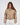 Thea Beige puffer coat for women with high neck and silver ring zipper pull worn by model.