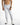 Luka White Jeans featuring distressed moto ribbing, tapered legs, and subtle paint splatter for a streetwear look.