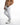 Side view of Luka white jeans featuring moto-ribbed knees, distressed detailing, and a streetwear aesthetic.