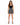 A woman stands confidently in a fitted black crop top paired with a patterned skirt and strappy heels.