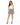 A model poses in a fitted white top and a flared black and white leopard print skirt, paired with strappy heels.