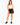 Woman in black sweat shorts and a white crop top, front view
