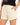 Close up of cream sweat shorts showing the drawstring and curved hem