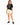 Woman in cream drawstring sweat shorts and a black graphic tee with black sneakers