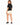 Back view of cream sweat shorts worn with a black tee and black sneakers