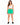 Woman in green drawstring sweat shorts and a white tank, three-quarter view