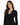 A woman with long, wavy hair wears a black long-sleeve top featuring a decorative chain and button neckline.