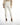 Rear view of Maisie white high-waisted tailored trousers, paired with black heels for a streetwear vibe.