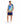 A man stands wearing a colorful short-sleeve shirt with tropical designs and matching shorts, paired with white sneak...