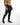 Side view of Marco dark blue denim jeans with distressed knees and urban wash on a male model.