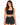 A woman with long, wavy hair wears a fitted black crop top and high-waisted black denim shorts.