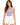 A woman with long, wavy hair wears a lilac crop top paired with white high-waisted shorts.