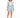 A woman with curly hair wears a light blue blazer and matching shorts, paired with a white crop top and sneakers.