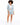 A model poses in a light blue blazer paired with matching shorts and white sneakers, showcasing a casual look.