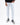 Men's Elliott white distressed jeans with knee rips, styled with black high-top sneakers by Carbon.