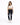 A woman stands confidently in a cropped white top and dark skinny jeans with distressed details, paired with white sn...