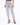 Light blue distressed jeans with a high waist and ripped details, paired with black strappy heels.