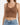 Brown ribbed crop top with a v-neck and gathered detailing, paired with light blue high-waisted jeans.