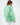 Back view of the Eve Top in mint green featuring white 'More And Less' graphic text on an oversized crewneck sweatshirt.
