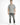 A man stands confidently in a short-sleeve, black and white patterned shirt paired with distressed gray jeans and whi...