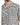 A close-up of a short-sleeve shirt featuring a black and white square pattern with a chest pocket.