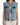 Denim vest with a relaxed fit, featuring a button-up front and two chest pockets, layered over a green top.