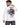 A man wearing a long-sleeve white shirt with a colorful Rubik's cube graphic and text on the back.