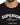 Black shirt featuring bold white embroidered text with a casual crew neckline.