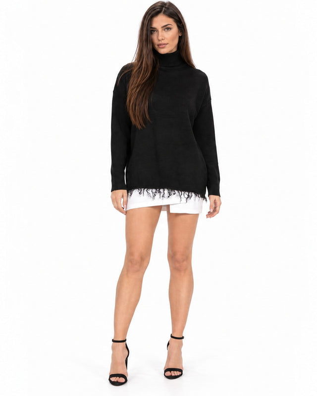 Celine Sweater in Black – full-length front view of a turtleneck with frayed fringe hem, worn with a white skirt