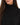 Celine Sweater in Black – close-up of the ribbed turtleneck collar and knit texture on a model