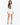 Nina Skirt Set in White – full-length front view of cropped one-button blazer and asymmetric wrap mini skirt