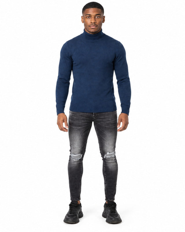 Tyson Sweater in Navy Blue – full-length front view of the turtleneck with ribbed cuffs and hem, worn with ripped black jeans