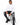 Tyson Sweater in White – seated model in white turtleneck with ripped black jeans