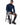 Tyson Sweater in Navy – seated model in the turtleneck with ribbed cuffs, worn with ripped black jeans