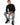 Romeo Turtleneck Sweater in Black – model seated on a stool, worn with grey ripped-knee jeans
