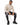 Tyson Sweater in Beige – seated model in the ribbed turtleneck worn with black ripped-knee jeans