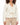 Rhea Jacket in Cream – front view on model with notched collar, flap pockets and rope drawstring waist