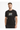 A man wearing a black t-shirt featuring a colorful geometric design on the front, standing against a white background.