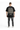 A person wearing a black oversized t-shirt with a checkerboard design and motivational text on the back.