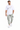 A man wearing a white graphic t-shirt and light green cargo pants, paired with white sneakers.